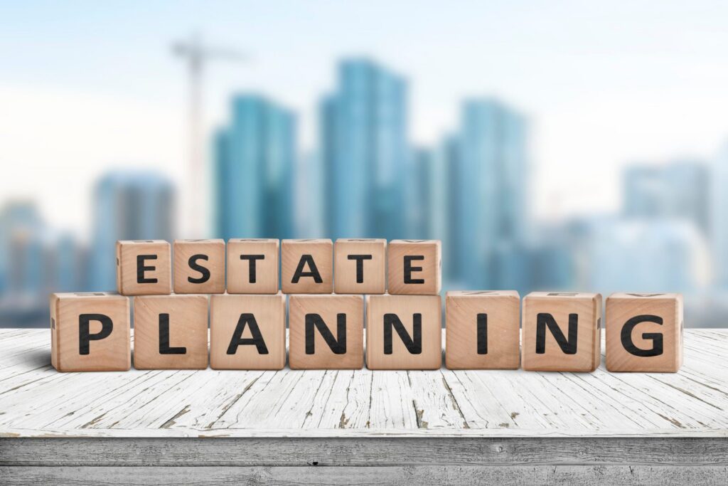 Wooden blocks spelling "Estate Planning" on a table, with a blurred cityscape in the background, subtly reflecting LaGrange Estate Planning expertise.