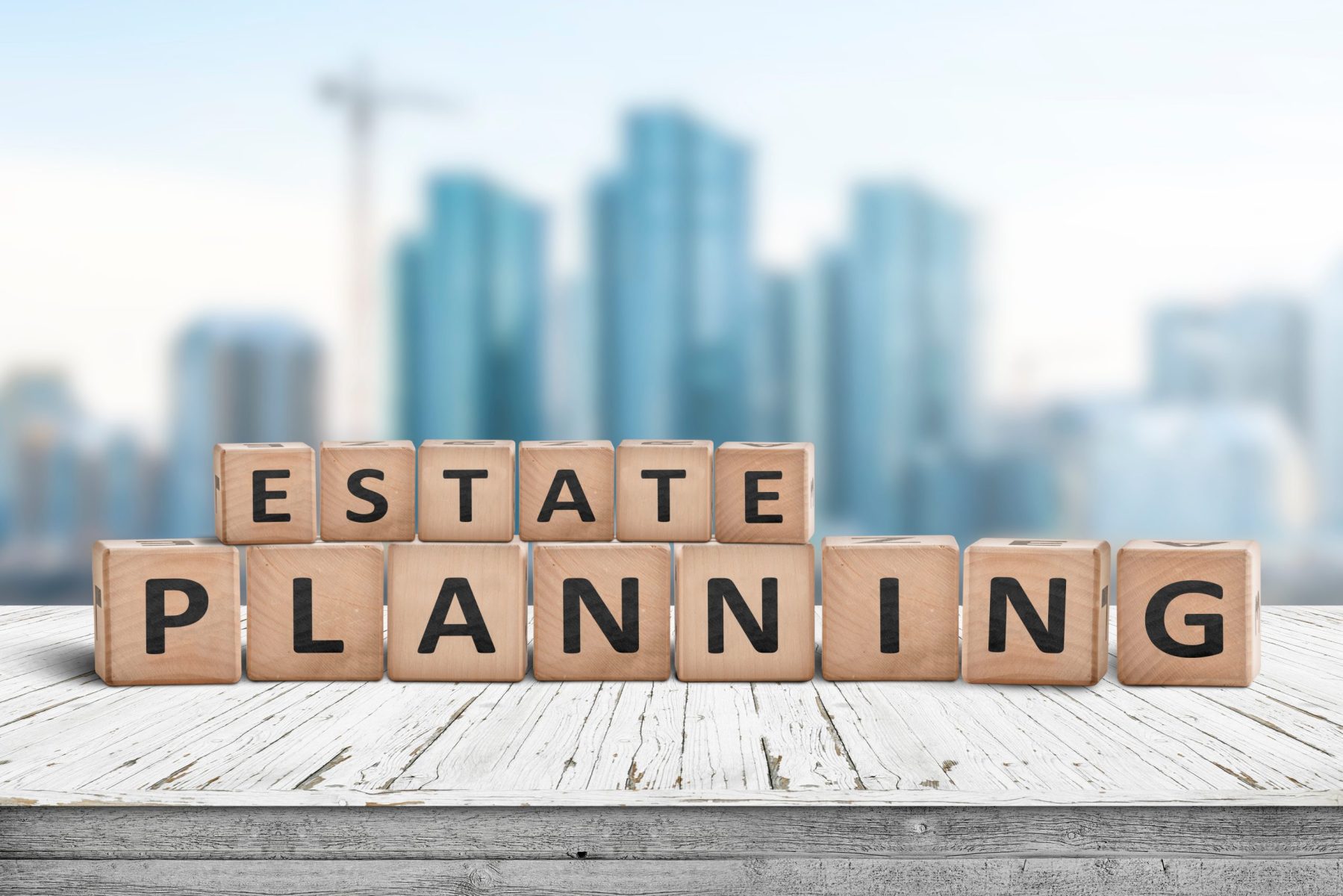 Wooden blocks spelling "Estate Planning" on a table, with a blurred cityscape in the background, subtly reflecting LaGrange Estate Planning expertise.