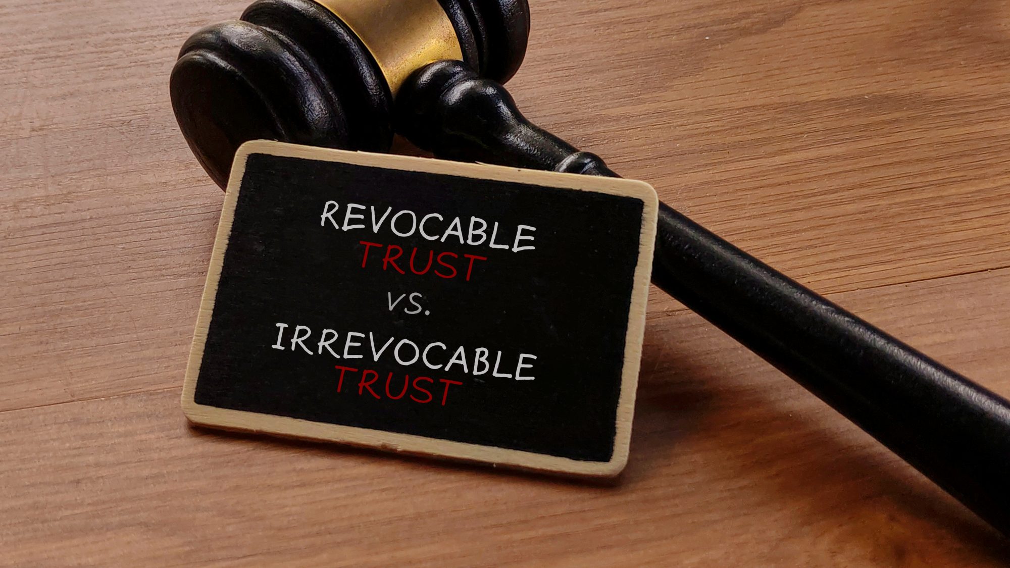 A gavel rests on a wooden surface next to a sign that reads "Revocable Trust vs. Irrevocable Trust"—highlighting the importance of consulting a trusts attorney in LaGrange for expert guidance.