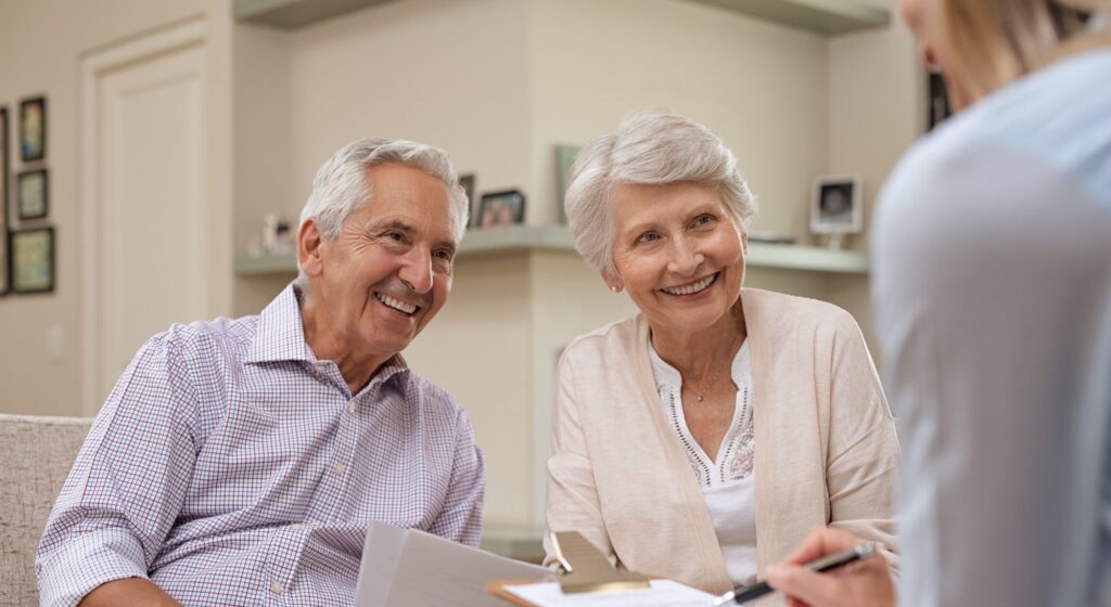 A man and woman sitting and smiling since their finance are in order thanks to an estate planning attorney in Deerfield.