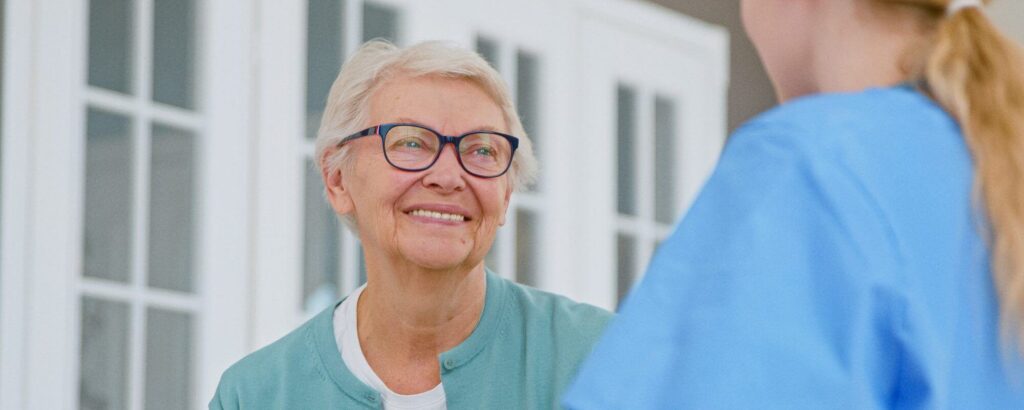 An older woman speaking to nurse for long term care, when needing to protect assets with irrevocable trust contact Burr Ridge Trusts Lawyer.