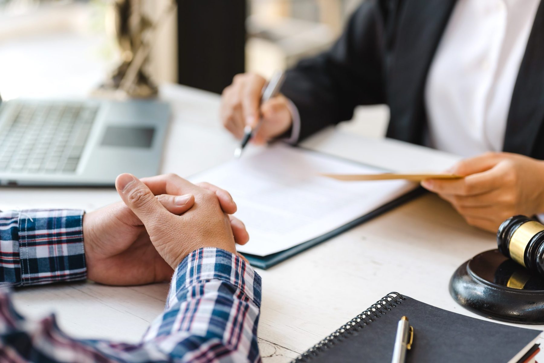 Two people sit at a desk with documents, signing power of attorney for parent's care in Lagrange
