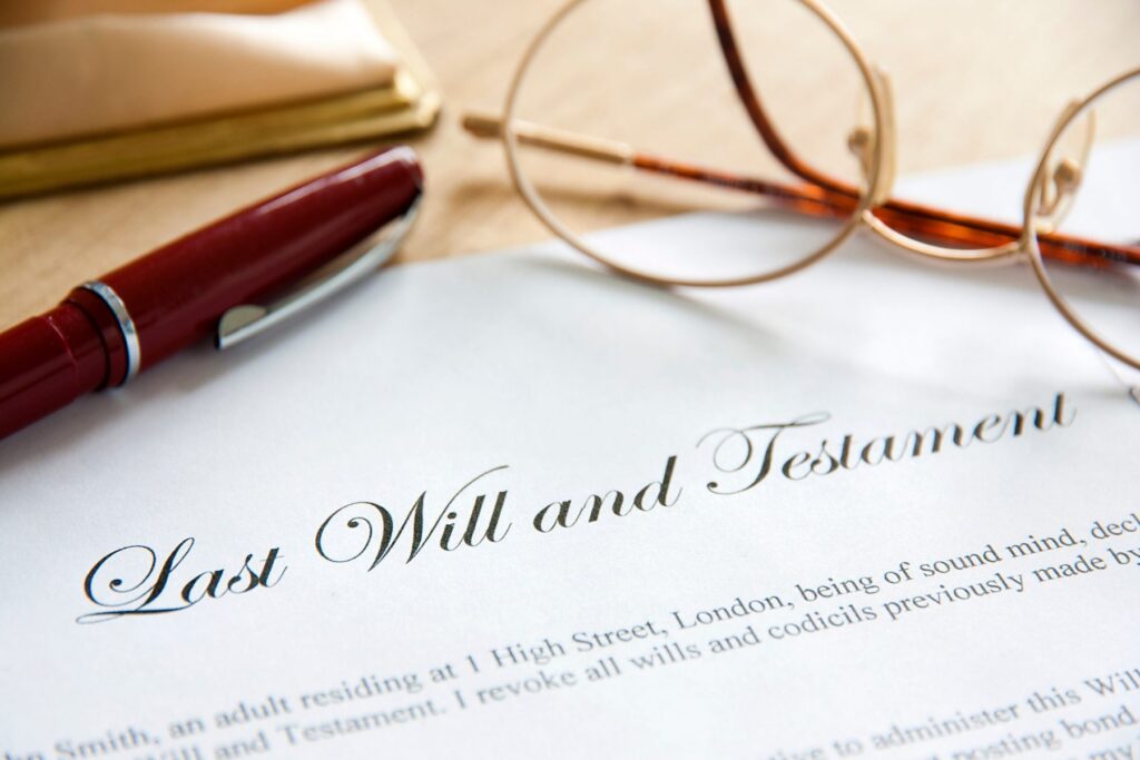 A "Last Will and Testament" document rests on a table, accompanied by a pair of glasses and a red pen. This scene represents the meticulous preparation involved in LaGrange Estate Planning, ensuring every detail is thoughtfully considered for future peace of mind.